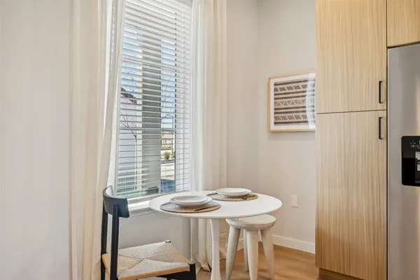 a view of a dining room with a table and chairs