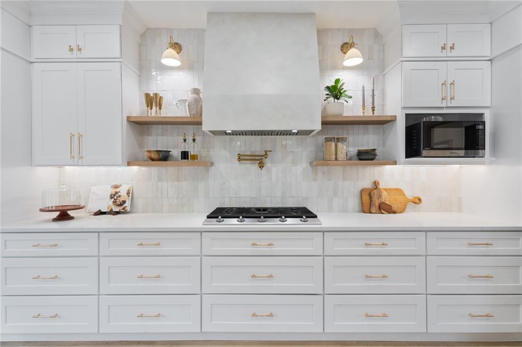 2625 Crosswynd Terrace Cumming, GA 30040 - Photo 8 of 20 a kitchen with white cabinets and appliances