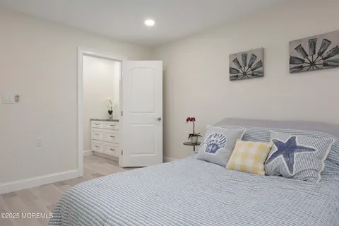 a bathroom with a granite countertop sink a toilet and a shower