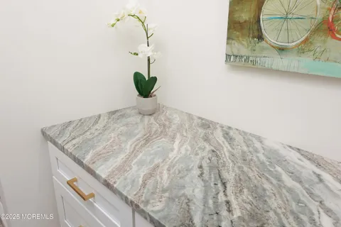 a bathroom with a granite countertop toilet sink mirror and vanity