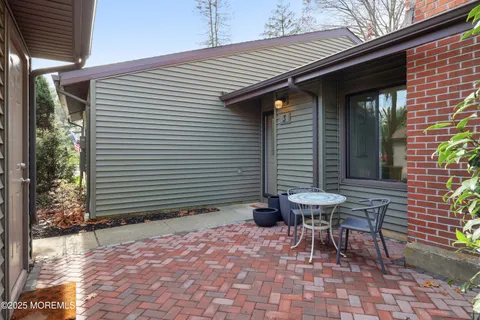 a backyard of a house with table and chairs