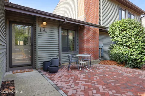 a view of a patio with table and chairs and potted plants