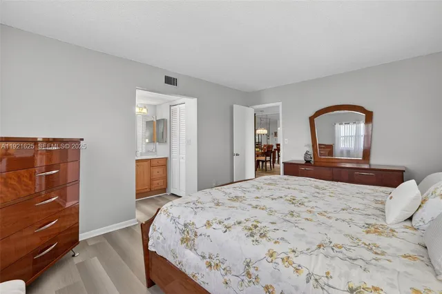 a bathroom with a sink a toilet and a large mirror