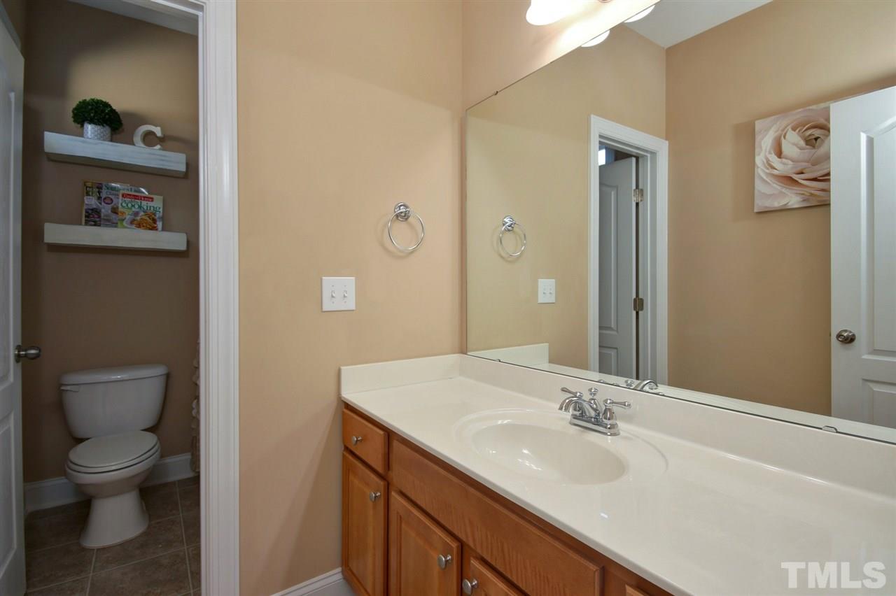 620 Democracy Street Raleigh, NC 27603 - Photo 22 of 24 Upstairs full bath with separate water closet and large vanity.