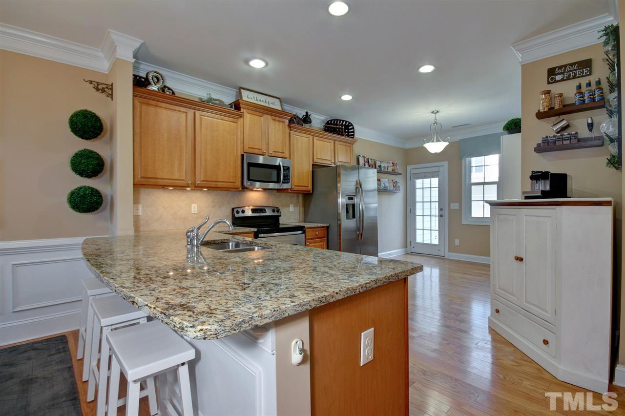 620 Democracy Street Raleigh, NC 27603 - Photo 9 of 24 Large breakfast bar and granite counter tops.