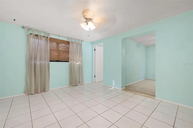 a view of a room with a chandelier fan and closet