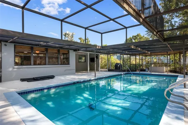 a view of a swimming pool with a patio