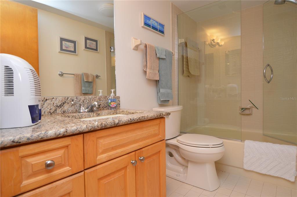 900 Gulf Boulevard, Unit 907 Indian Rocks Beach, FL 33785 - Photo 54 of 88 a bathroom with a granite countertop sink toilet and shower