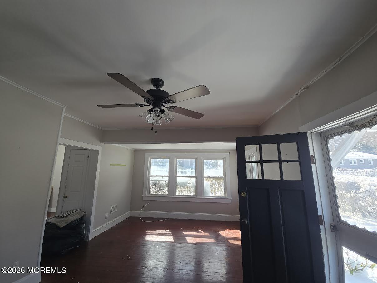 254 First Avenue Atlantic Highlands, NJ 07716 - Photo 2 of 18 a view of empty room with wooden floor and fan