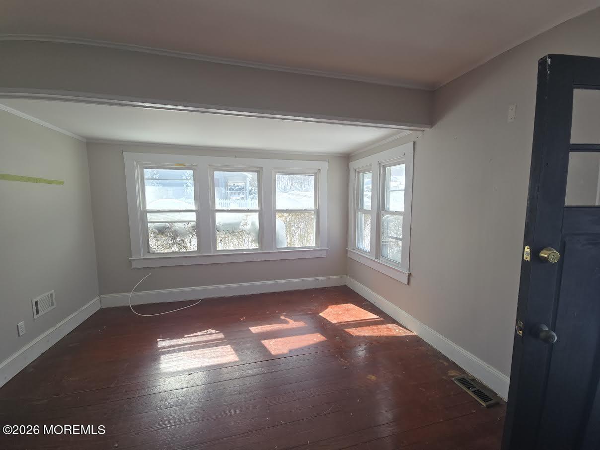 254 First Avenue Atlantic Highlands, NJ 07716 - Photo 3 of 18 a view of empty room with wooden floor and fan