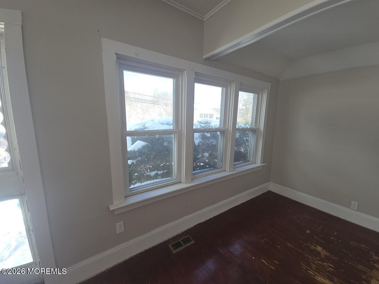 254 First Avenue Atlantic Highlands, NJ 07716 - Photo 4 of 18 a view of an empty room with wooden floor and a window