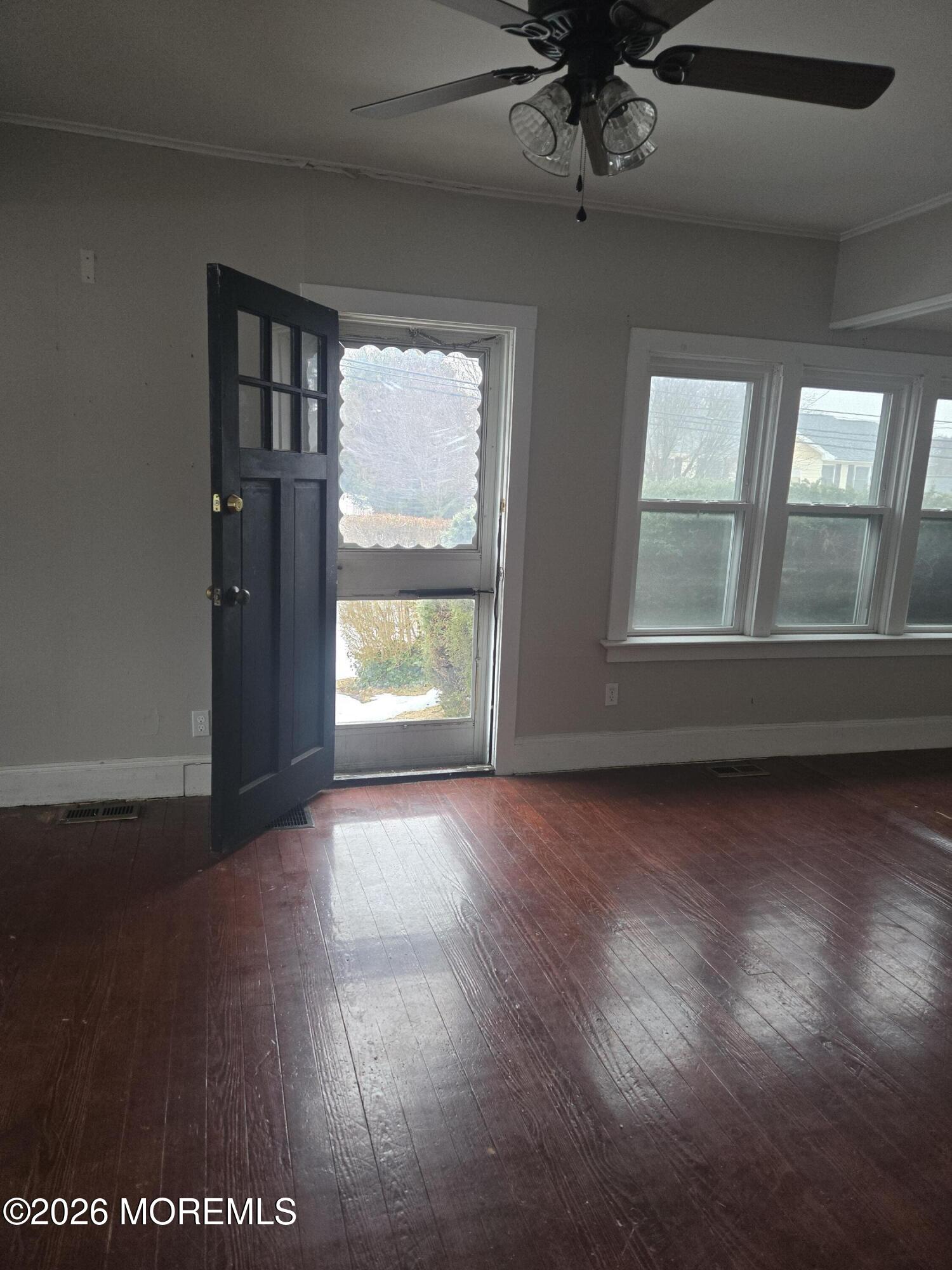 254 First Avenue Atlantic Highlands, NJ 07716 - Photo 5 of 18 an empty room with wooden floor and windows