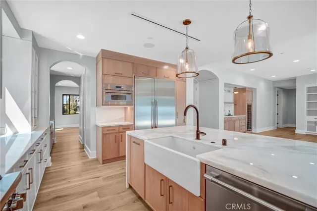 a view of a utility room with cabinets and wooden floor