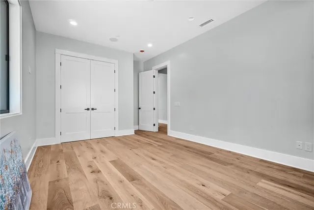 a kitchen with a stove and a white wooden cabinets