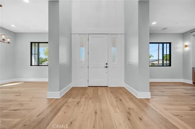 a view of a kitchen with cabinets stainless steel appliances and a chandelier
