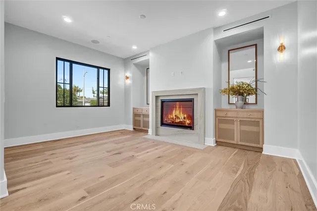 a large kitchen with stainless steel appliances kitchen island a large counter top a stove a chimney a sink and a refrigerator