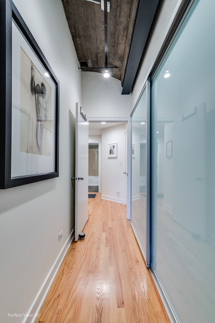 1128 West Ardmore Avenue, Unit 1 Chicago, IL 60660 - Photo 19 of 31 a view of hallway with wooden floor