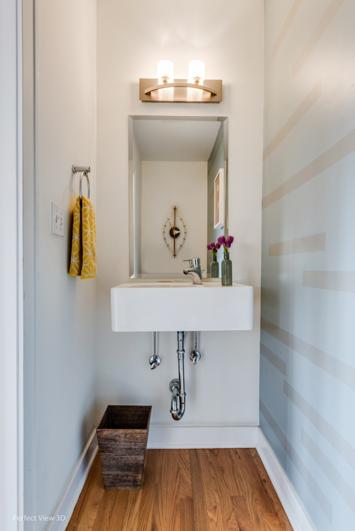 1128 West Ardmore Avenue, Unit 1 Chicago, IL 60660 - Photo 7 of 31 a bathroom with a sink and a mirror