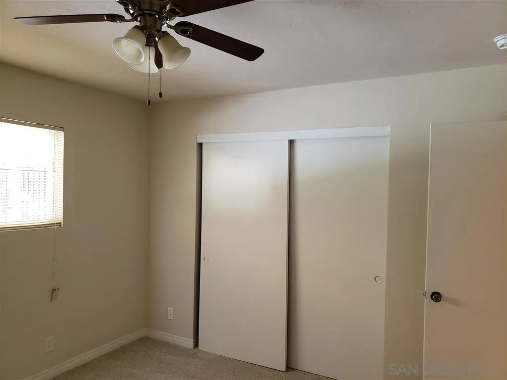 13425 Hilldale Road Valley Center, CA 92082 - Photo 8 of 13 a view of a hallway with a ceiling fan and a window