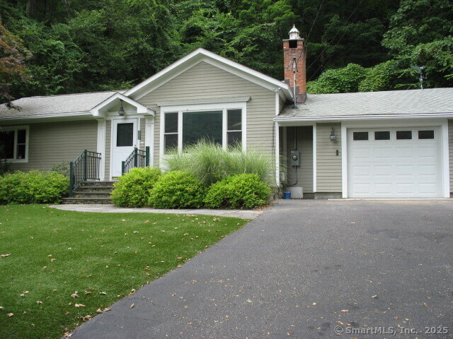 128 South Kent Road Kent, CT 06785 - Photo 1 of 1 a front view of a house with a yard and garage