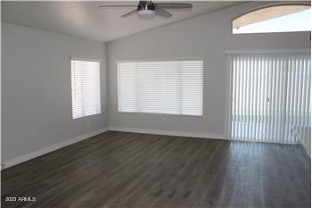 13402 East Boston Street Chandler, AZ 85225 - Photo 7 of 19 an empty room with wooden floor and windows