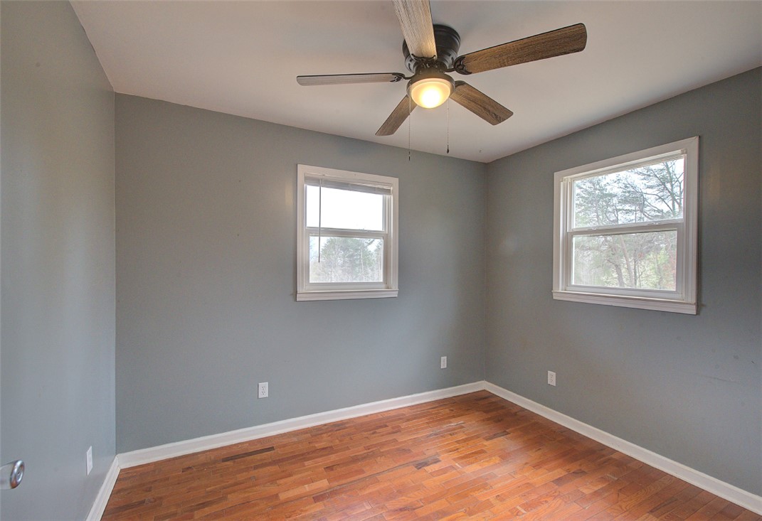 325 Rock Quarry Road Travelers Rest, SC 29690 - Photo 16 of 37 This inviting bedroom features rich hardwood flooring and abundant natural light.