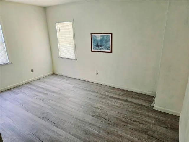 a view of an empty room with two window