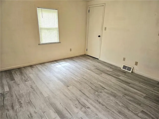 a view of an empty room and wooden floor