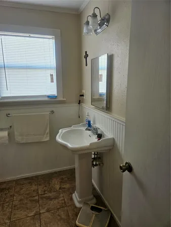 a bathroom with a sink a mirror and a toilet