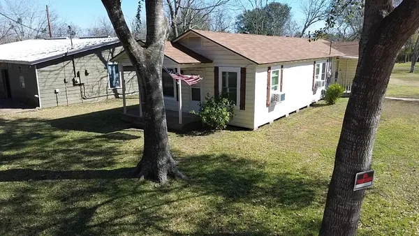a pathway of a house with a yard