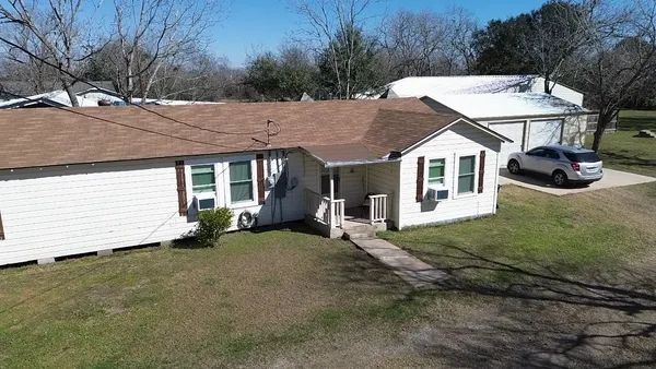 a view of a house with a yard and sitting area