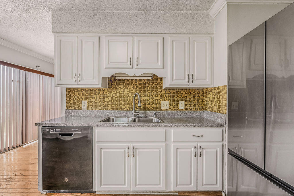 53 4th Street Shalimar, FL 32579 - Photo 16 of 47 a kitchen with white cabinets and sink