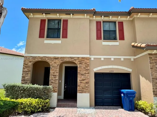 a front view of a house with a garage