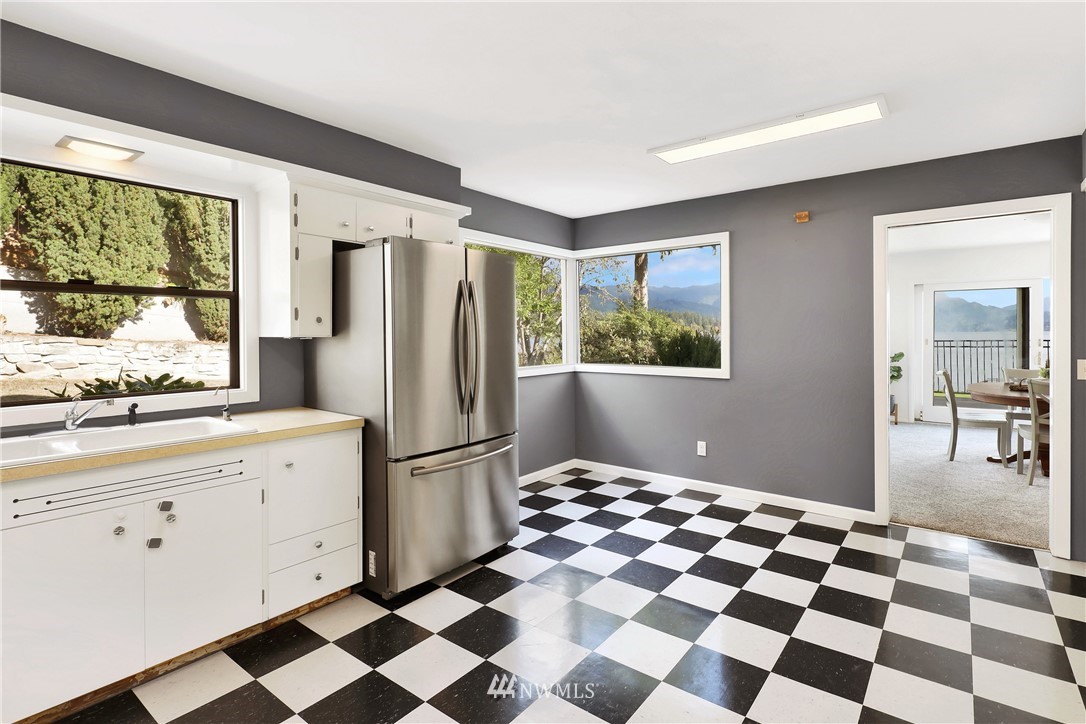2301 North Shore Road Bellingham, WA 98226 - Photo 15 of 40 a kitchen with a checkered floor and white cabinets