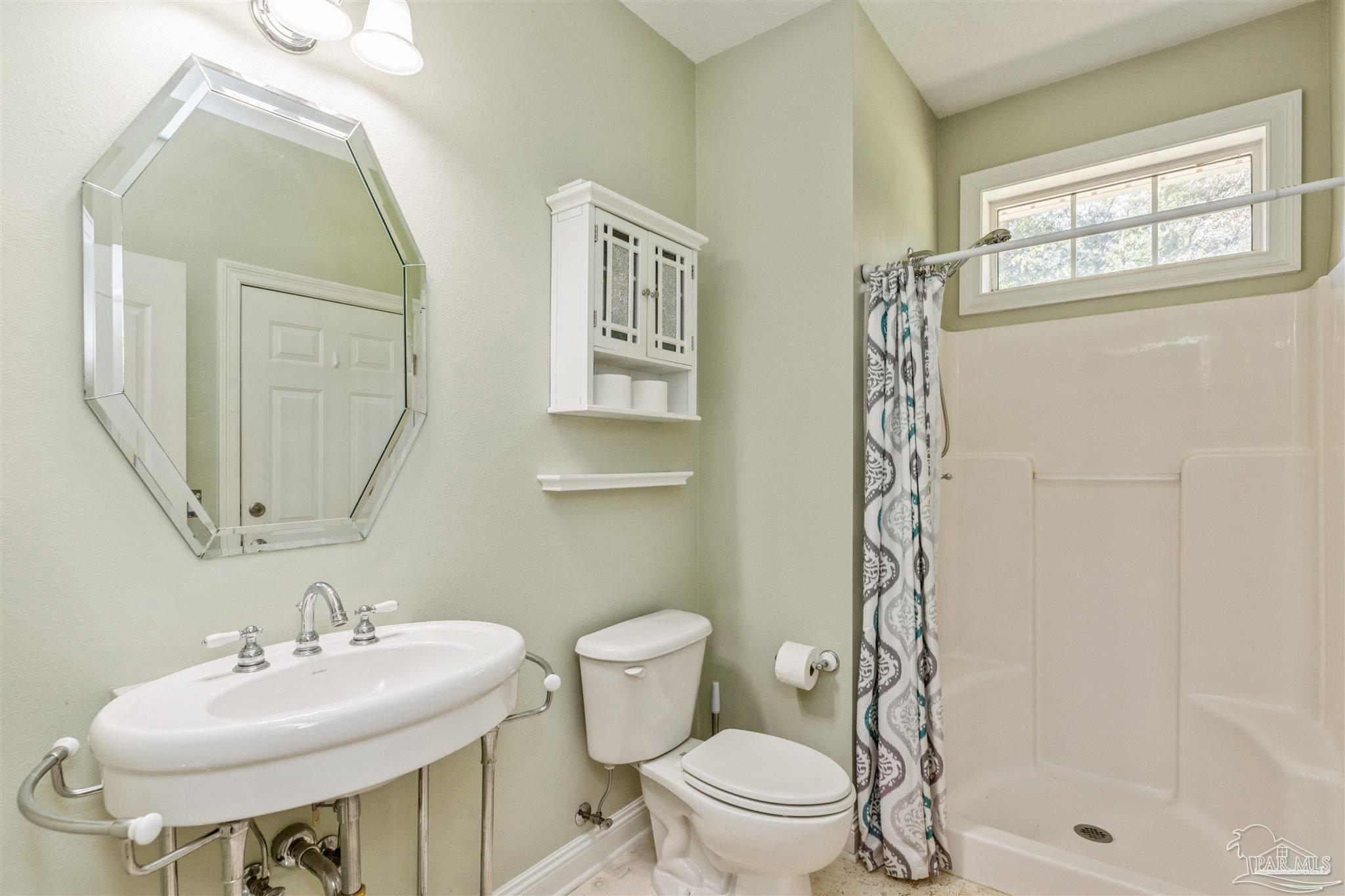 2855 Walling Road Milton, FL 32570 - Photo 46 of 55 a bathroom with a sink toilet and shower