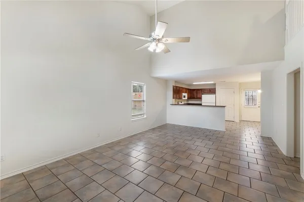a view of a livingroom with a ceiling fan and window