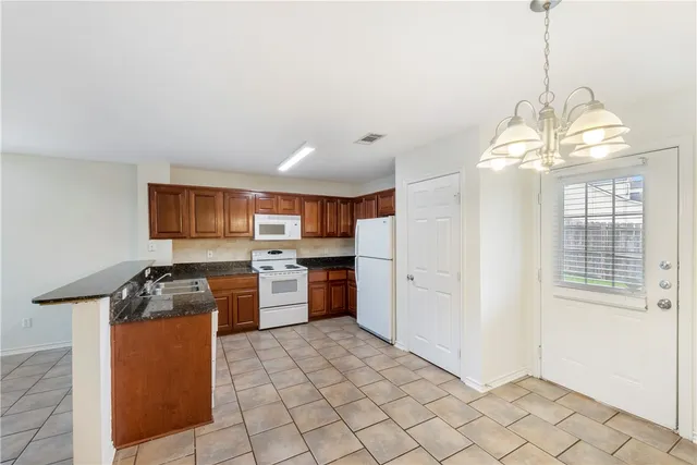 a kitchen that has a lot of cabinets in it