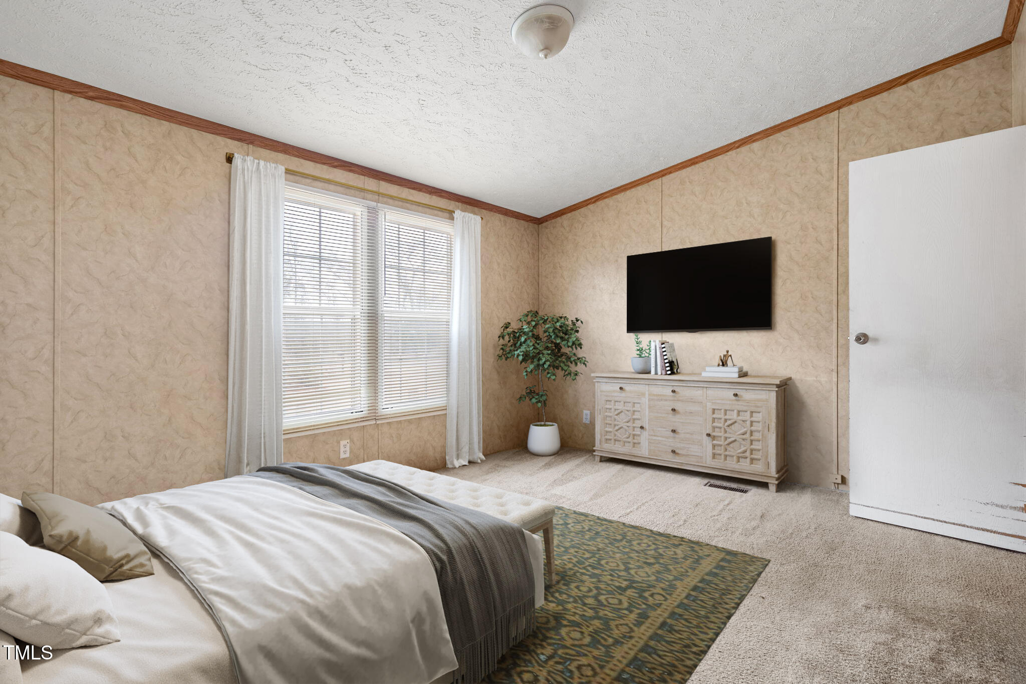 4210 Scronce Road Harrells, NC 28444 - Photo 16 of 28 a bedroom with a bed and a flat screen tv