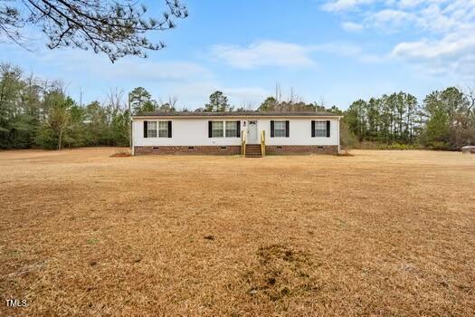 4210 Scronce Road Harrells, NC 28444 - Photo 2 of 28 a front view of a house with a yard and trees
