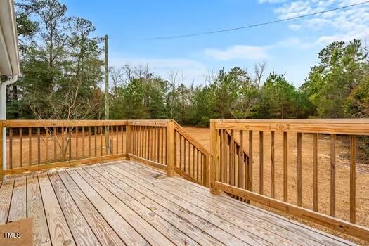 4210 Scronce Road Harrells, NC 28444 - Photo 24 of 28 a balcony with wooden floor and fence