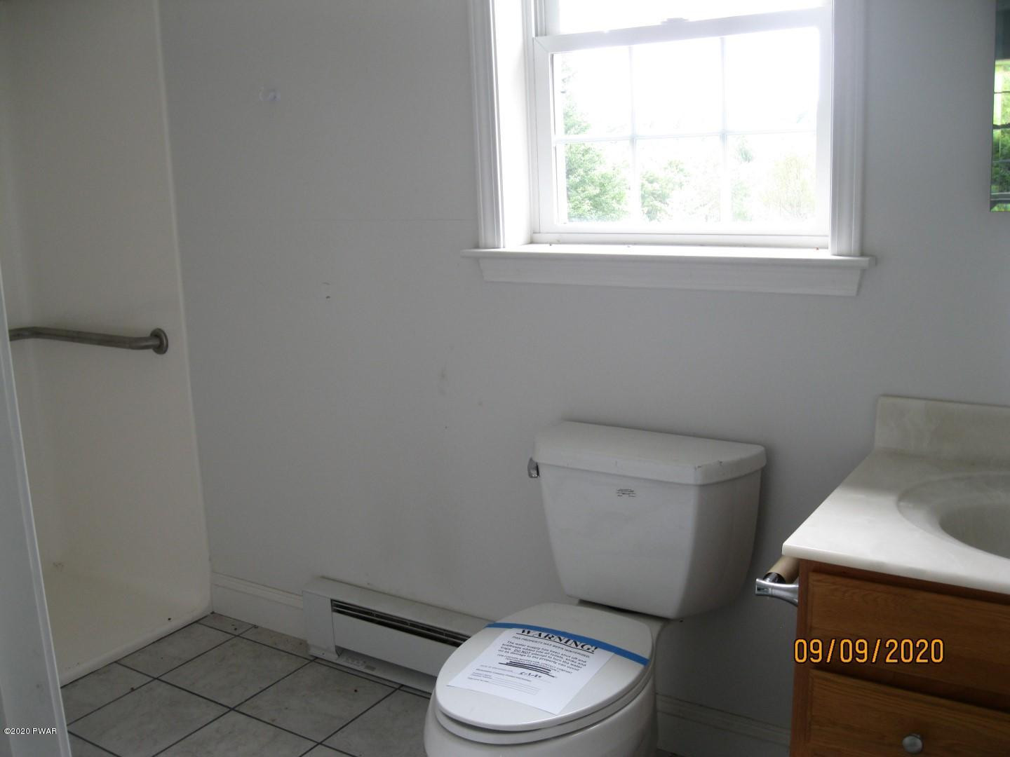 271 North Baker Road Waymart, PA 18472 - Photo 17 of 25 a white toilet sitting next to a window