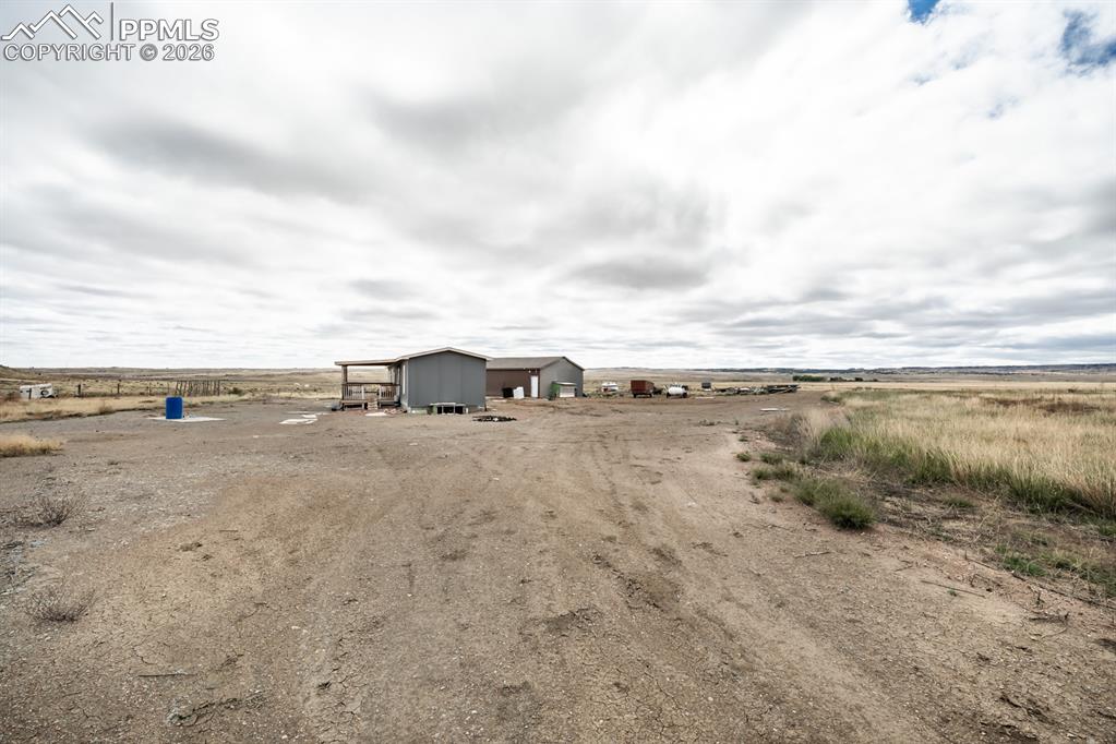 20630 Highstakes View Fountain, CO 80817 - Photo 2 of 13 View of yard featuring a rural view and an outbuilding