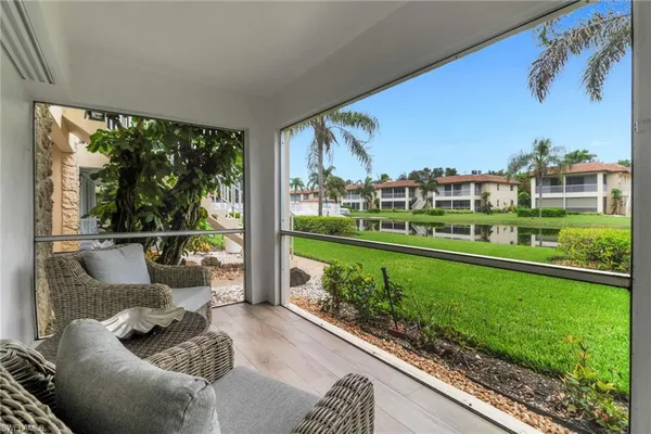 a view of a couches in a patio with a yard