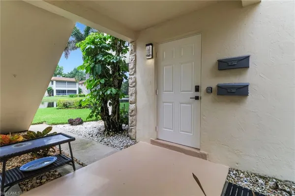 a view of a patio with table and chairs with potted plants
