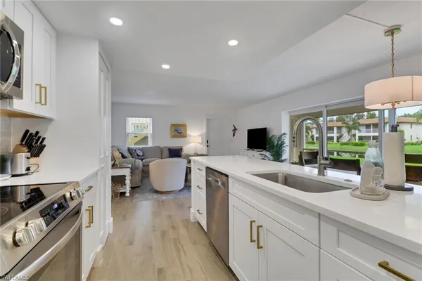 a kitchen with sink stove and cabinets
