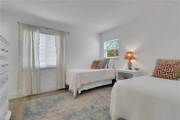 a bedroom with two beds and a window