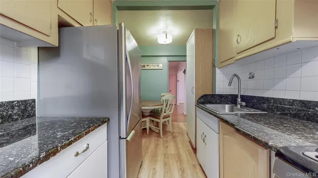 a kitchen with sink and mirror