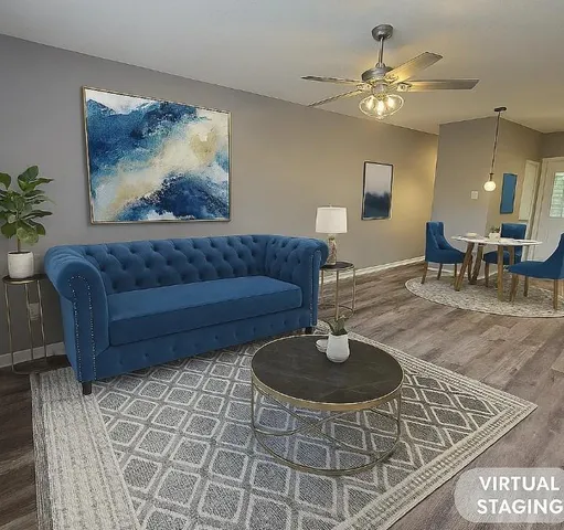 a living room with furniture and a chandelier