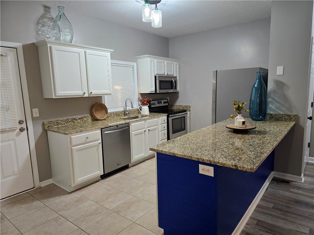 31 Corinth Road Cartersville, GA 30121 - Photo 2 of 35 a kitchen with stainless steel appliances granite countertop a sink stove and refrigerator