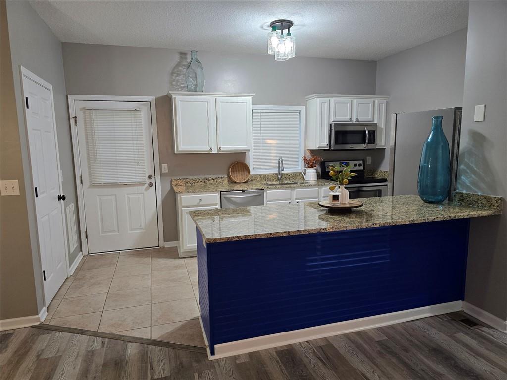 31 Corinth Road Cartersville, GA 30121 - Photo 3 of 35 a kitchen with stainless steel appliances a sink a stove a microwave a refrigerator a counter space and cabinets